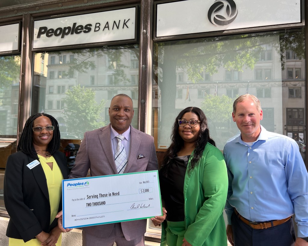 Peoples Bank employees present a check to the Serving Those in Need organization.