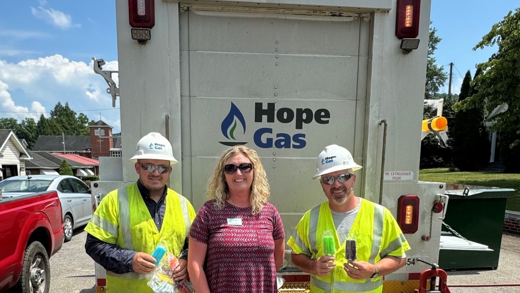 A Peoples Bank employee hands out popsicles to Hope Gas workers.