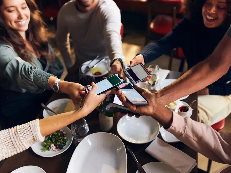 Group of friends split the bill using Zelle while at dinner.