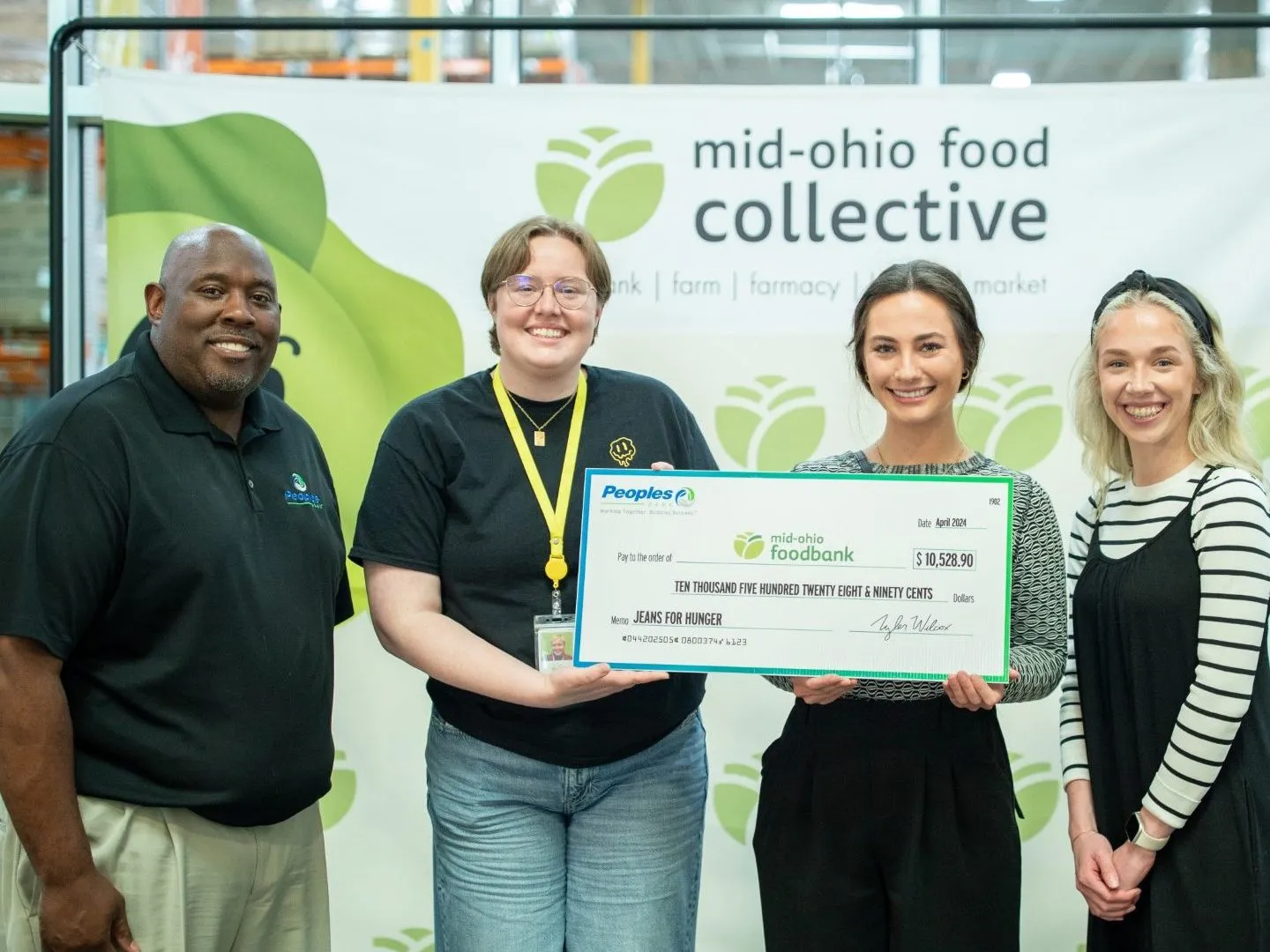 Three Peoples Bank employees present a check to the Mid-Ohio Food Collective.