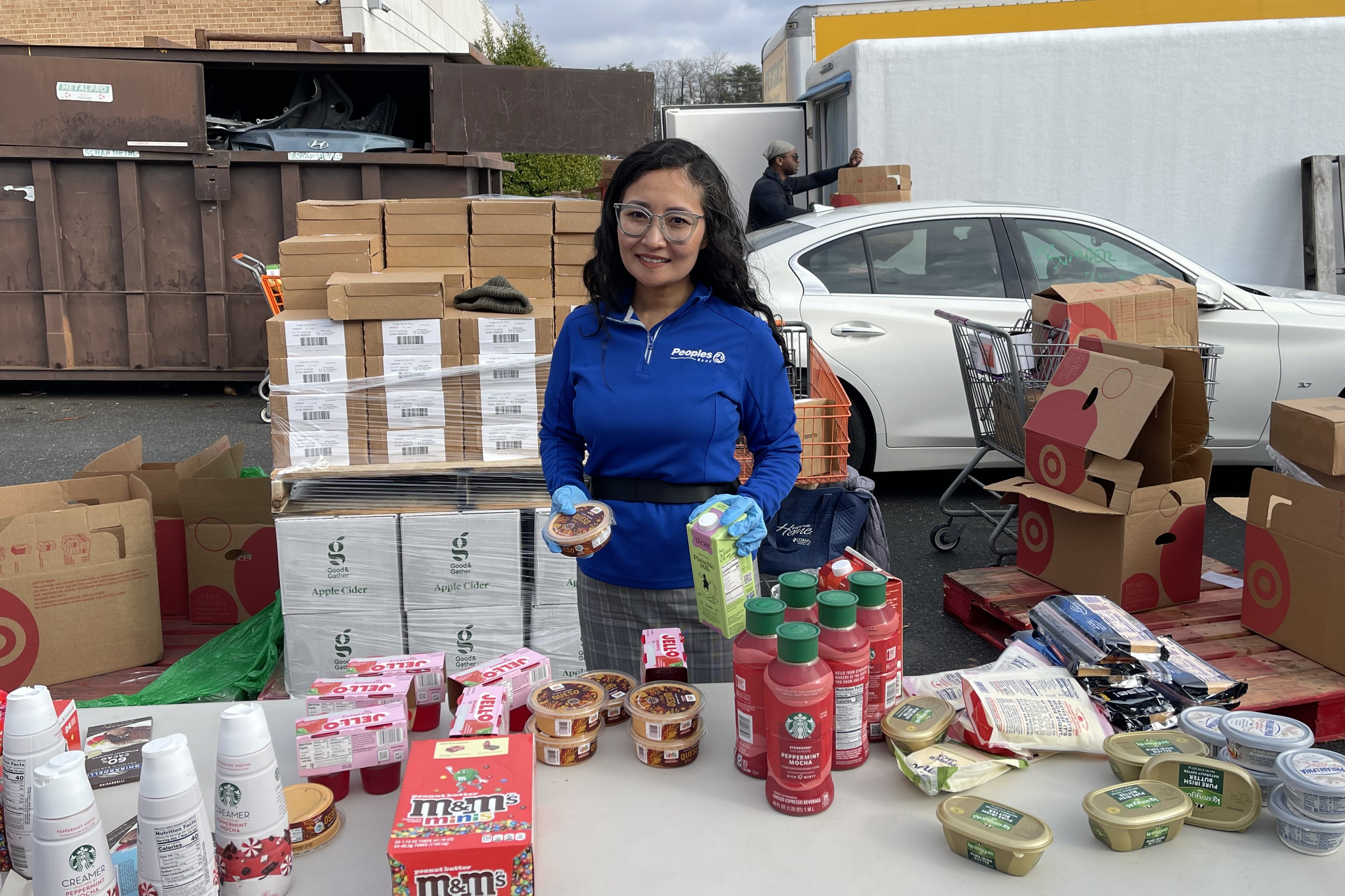 Peoples Bank employee packages canned goods for a local food drive.