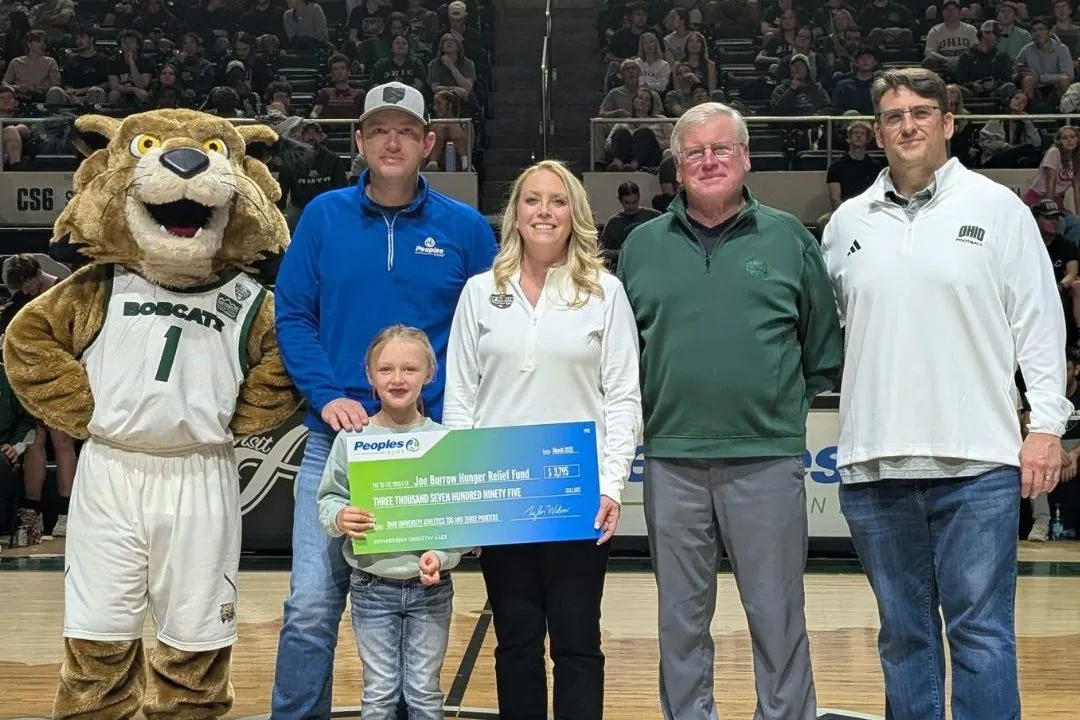 Peoples Bank associates present a check to the Joe Burrow Hunger Relief Fund