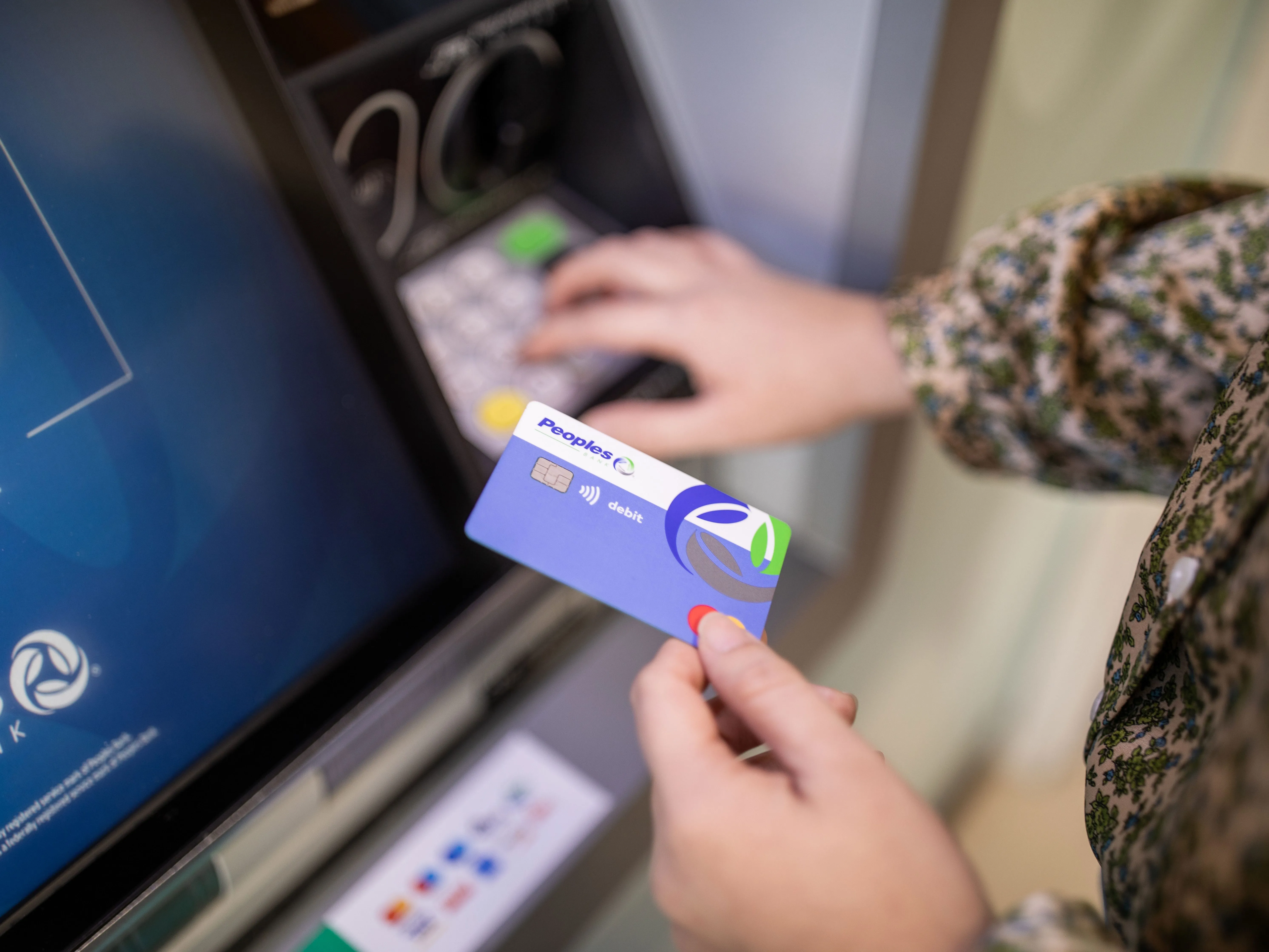 Customer uses a Peoples Bank Debit Card at an ATM.