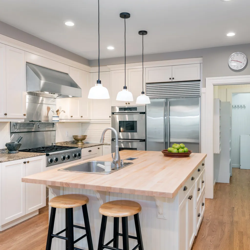 Kitchen Interior in white with wooden floor.