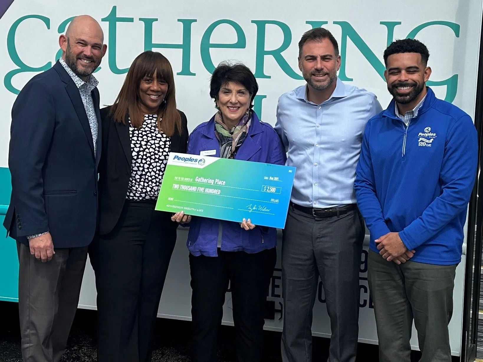 Three Peoples Bank associates present a donation to the Gathering Place in Beachwood, Ohio.