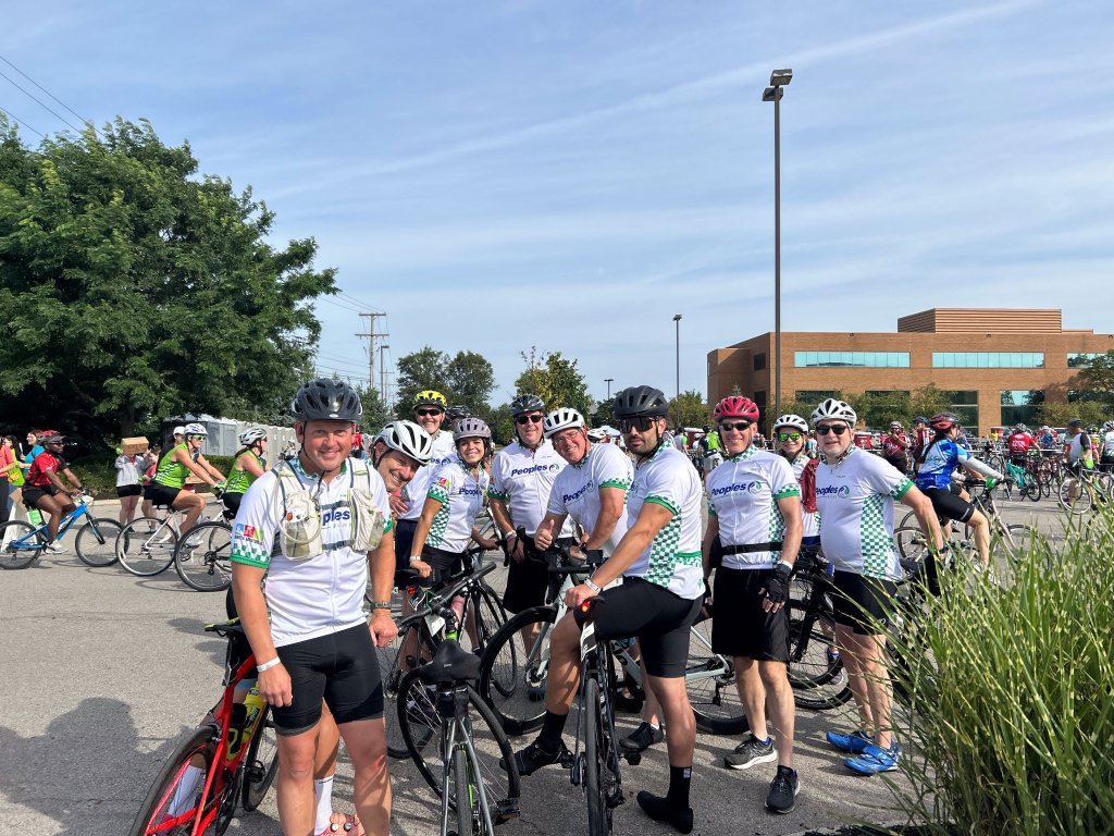 Nine Peoples Bank associates stand with their bikes at the Pelotonia Ride Weekend in Columbus, OH.