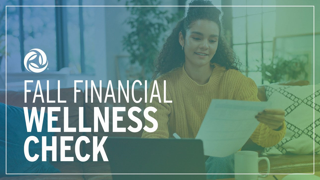 A woman holds and looks at a paper statement while sitting in her living room. A text overlay reads: Fall Financial Wellness Check.
