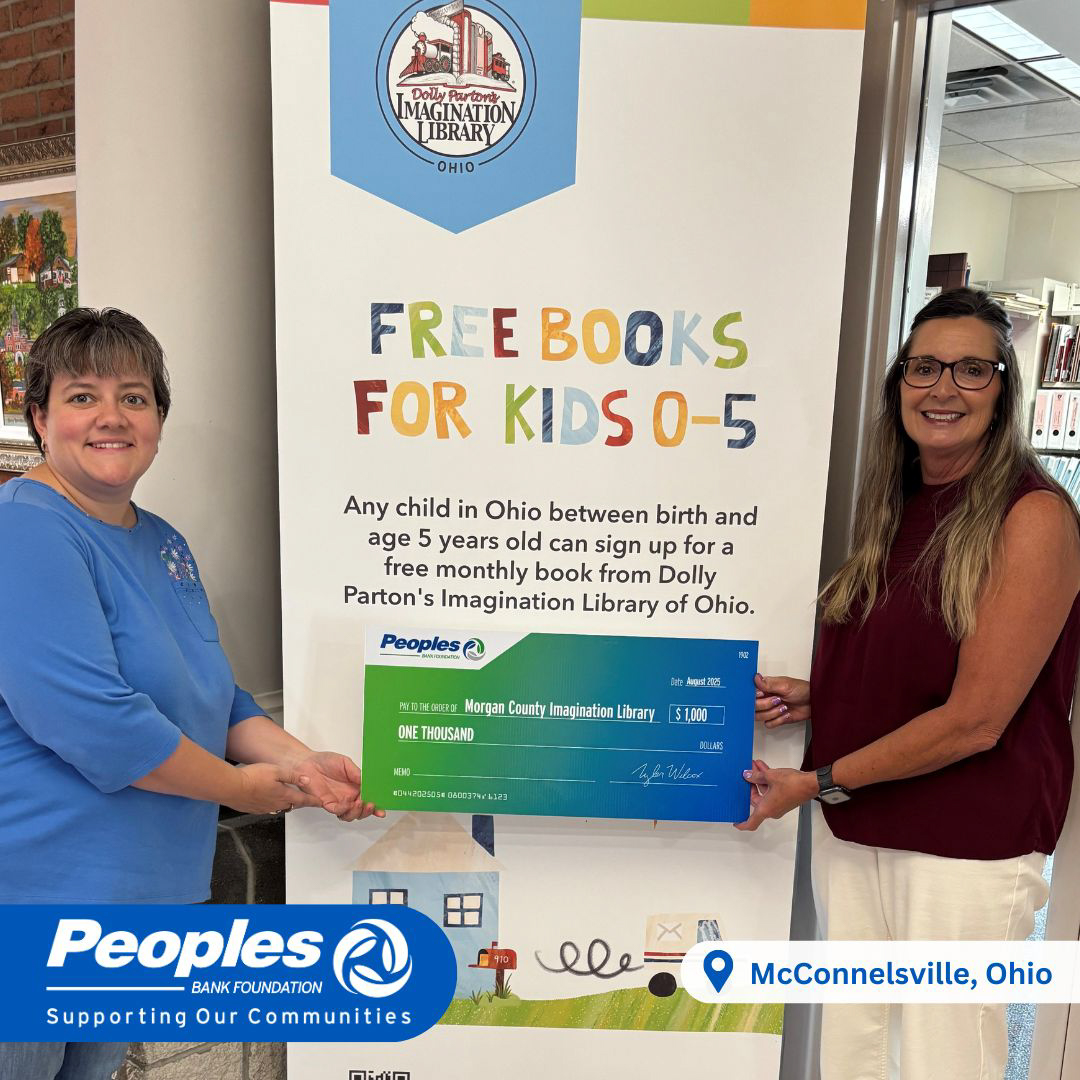 A Peoples Bank associate (right) presents a check for $5,000 to a Morgan County Imagination Library worker (left)..