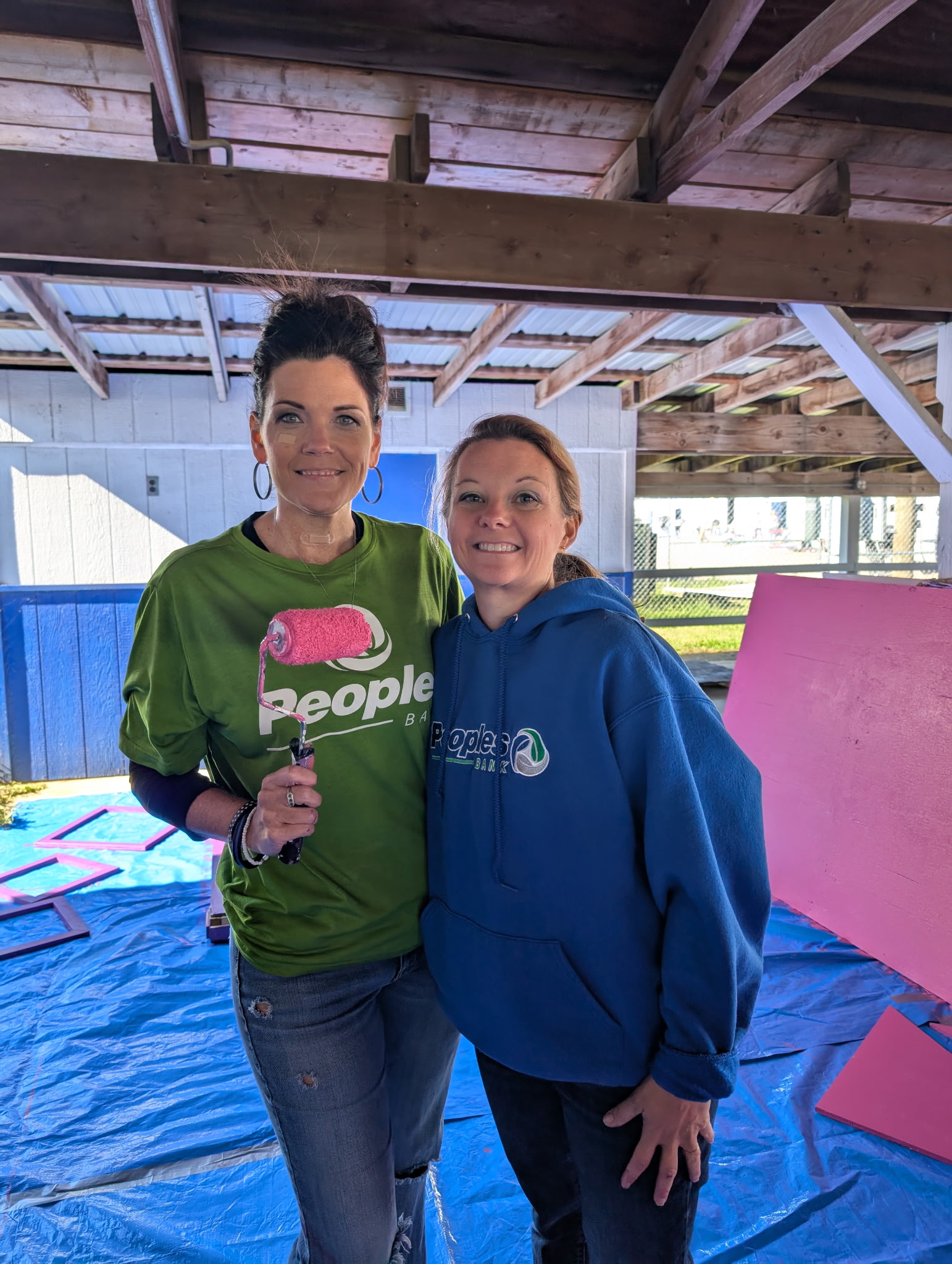 Two Peoples Bank associates volunteer at a Habitat for Humanity event in Zanesville, OH.