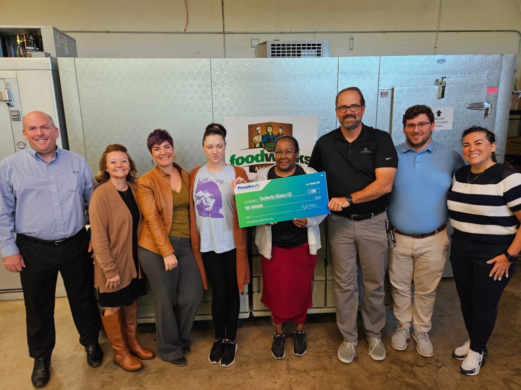 Four Peoples Bank associates present a monetary donation to four associates from the FoodWorks Alliance in Zanesville, OH.