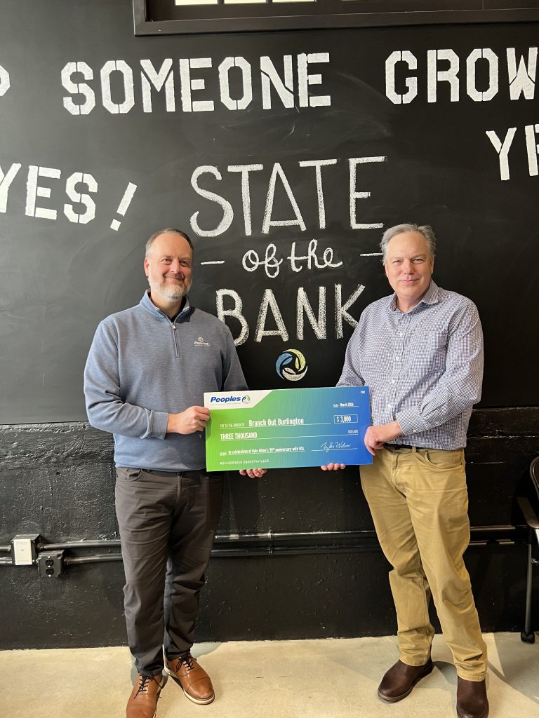 Peoples Bank President & CEO Tyler Wilcox (left) presents a jumbo check to Branch Out Burlington on behalf of Kyle Albee (right) of North Star Leasing, a division of Peoples Bank.