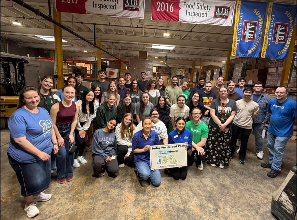 Over 30 Peoples Bank associates and volunteers pose for a photo at the Facing Hunger Foodbank in Huntington, West Virginia, after packing 38,033 meals.