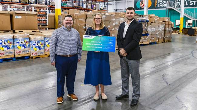 Two Peoples Bank associates present a $6,952 check to God Pantry Food Bank in Louisville, Kentucky.
