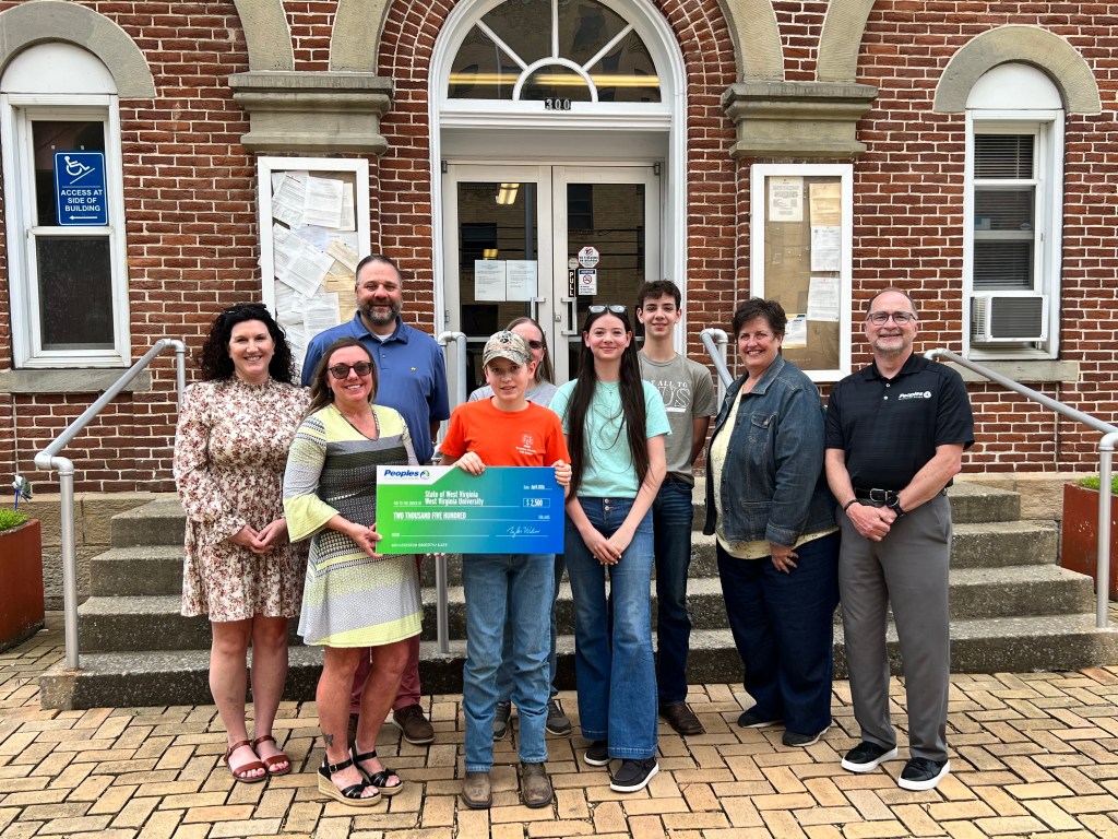 Nine Peoples Bank associates and students pose for a photo in front of the WVU-Braxton County Extension Office.