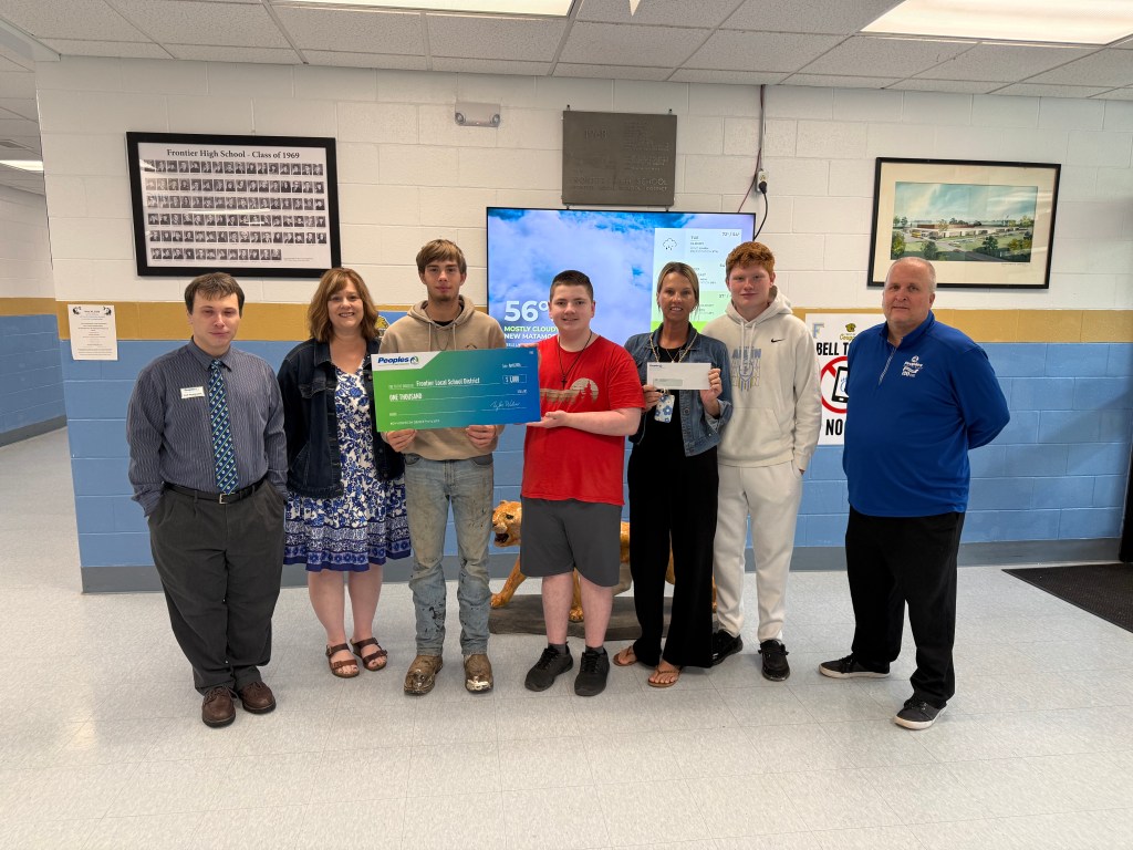 Three Peoples Bank associates stand with four students from New Matamoras School in Ohio to present a donation for the school's Wellness Zone.