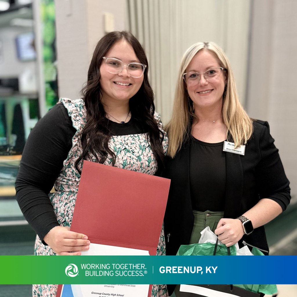 A high school student in Greenup, Kentucky, stands with a Peoples Bank associate for the Robert Evans Scholarship presentation.