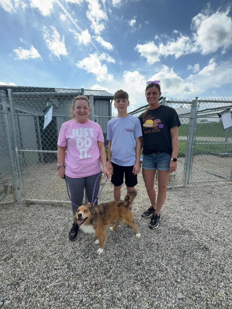 Two Peoples Bank associates stand with a shelter dog from the Brown County Humane Society in Mt. Orab, Ohio.