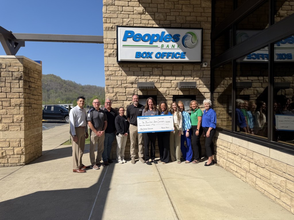 Eleven Peoples Bank and Mountain Arts Center associates stand in front of the event center's box office.