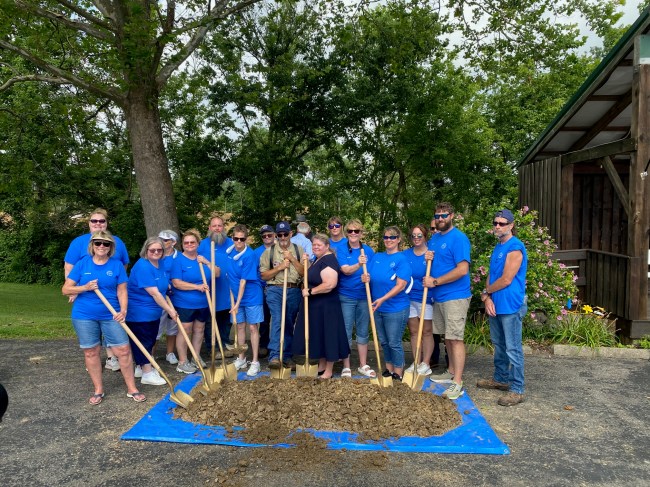 Members of Peoples Bank and the Veterans Village project hold shovels at a groundbreaking event.