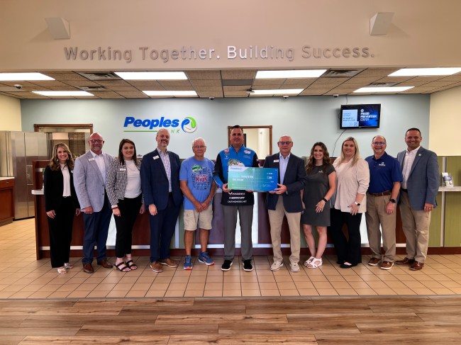 Thirteen Peoples Bank associates and representatives from the Casting for Kids organization come together for a donation in Paintsville, Kentucky.
