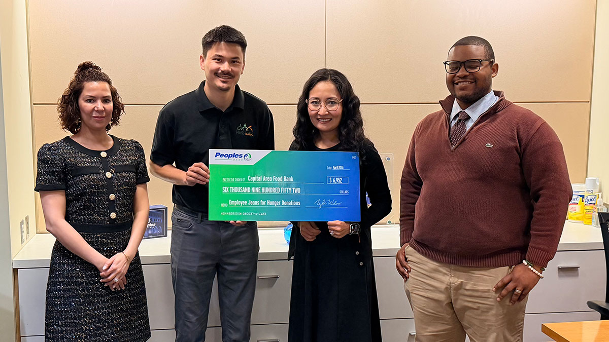Three Peoples Bank associates present a check to the Capital Area Food Bank in Washington, D.C.