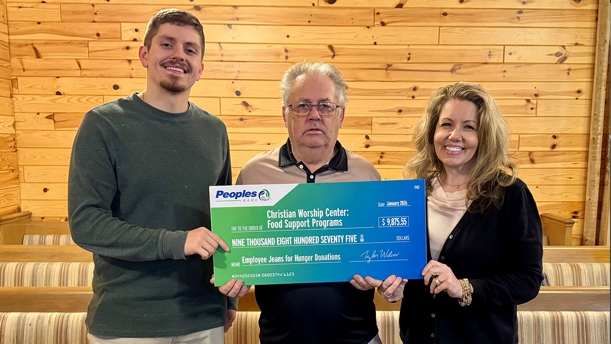 Two Peoples Bank associates present a check to the Christian Worship Center Food Pantry in Kentucky.