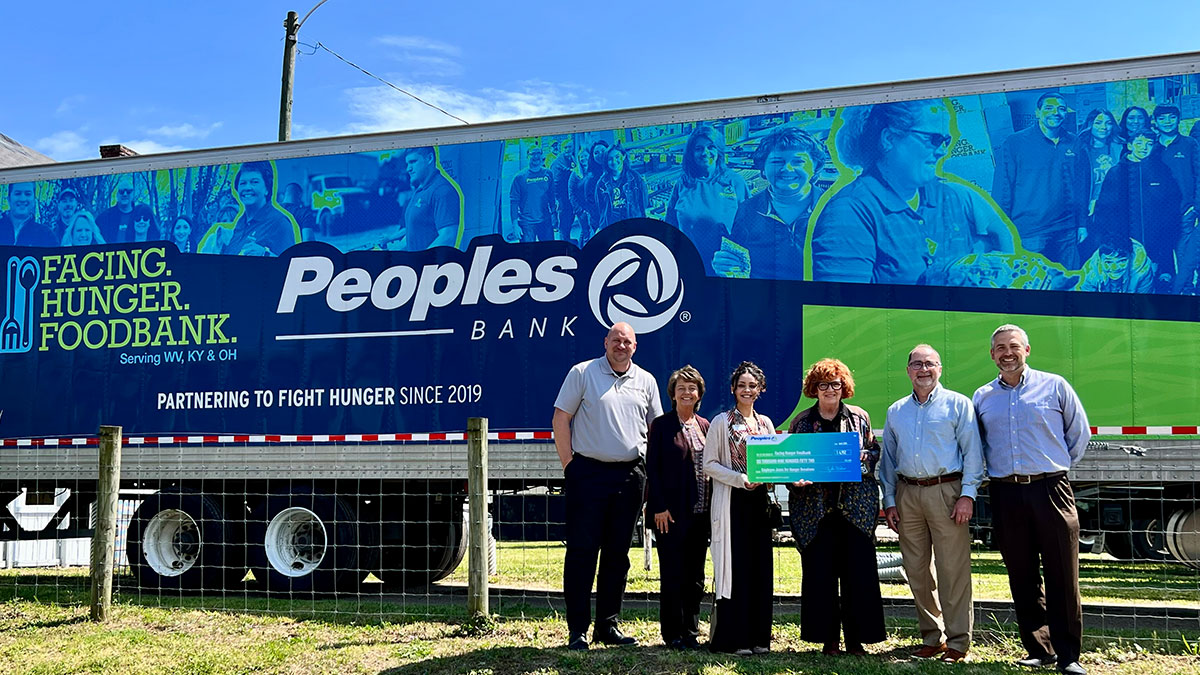 Four Peoples Bank associates present a check to the Facing Hunger Foodbank in Huntington, West Virginia.