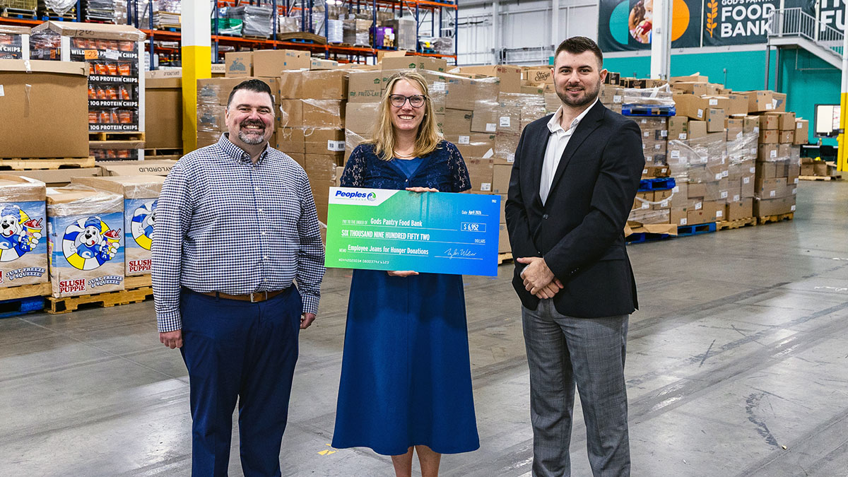 Two Peoples Bank associates present a check to the Gods Pantry Food Bank.