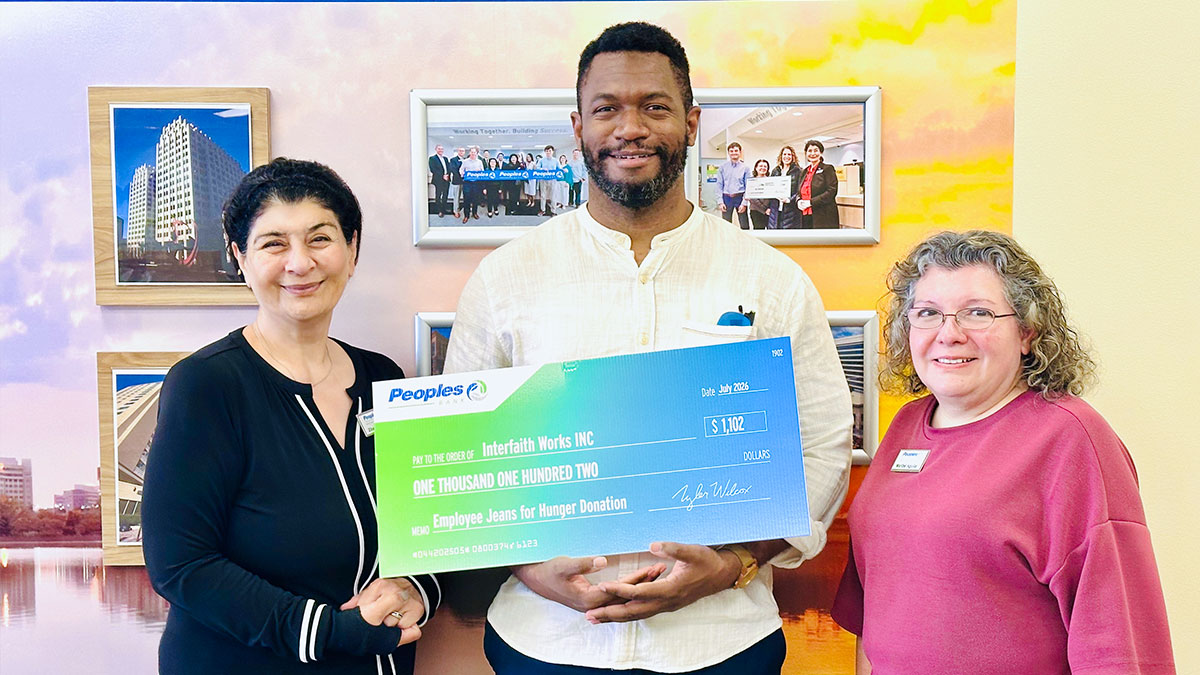 Two Peoples Bank associates present a check to Interfaith Works INC in Maryland