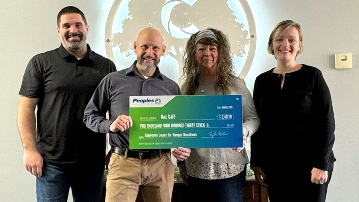 Two Peoples Bank associates present a check to Naz Cafe in Wilmington, Ohio.
