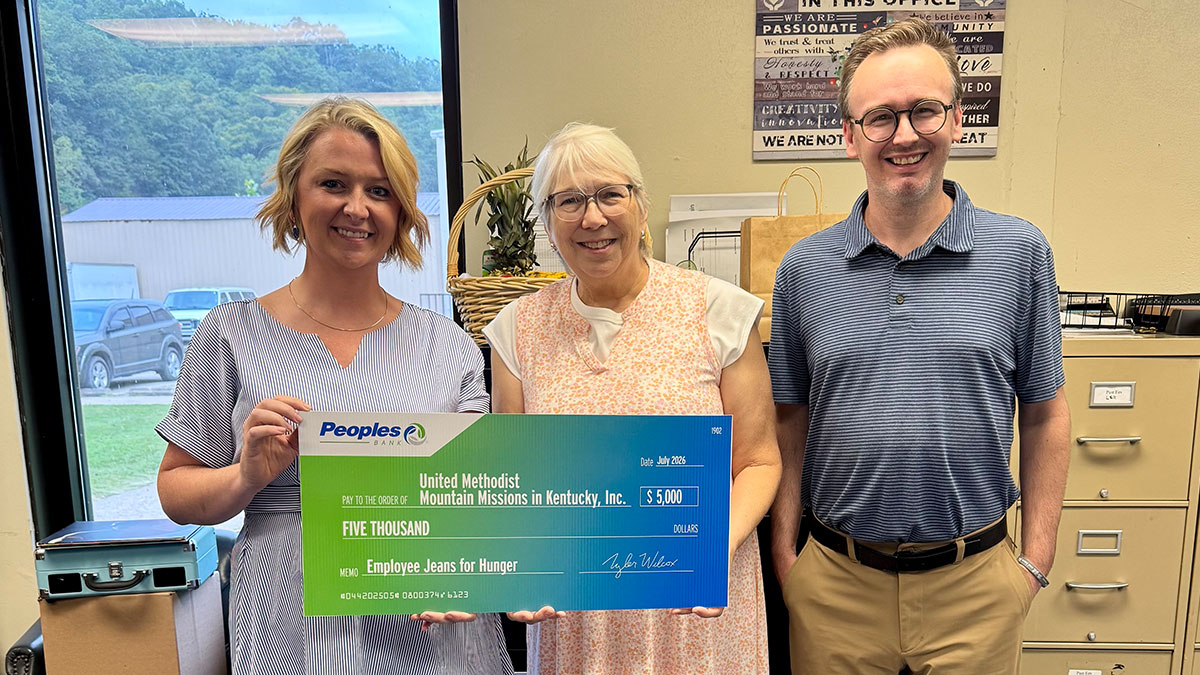 A Peoples Bank associate presents a check to the United Methodist Mountain Missions in Kentucky