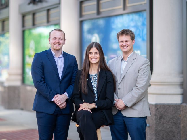 Three Peoples Bank Professional Development Associates pose in front of headquarters in Marietta, Ohio.