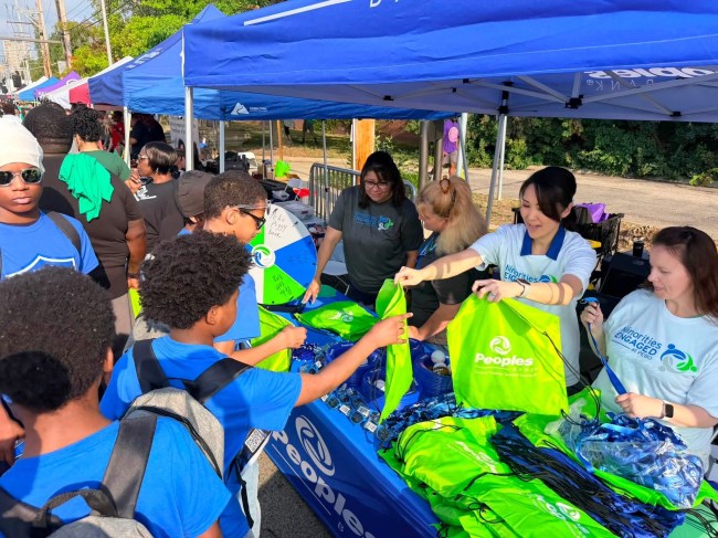 A group of Peoples Bank associates hand out swag items to participants of the African American Men Wellness Walk in Columbus, Ohio.