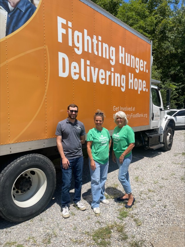 Three Peoples Bank associates stand in front of the Heaven's Harvest Food Pantry delivery truck in Martin, Kentucky.