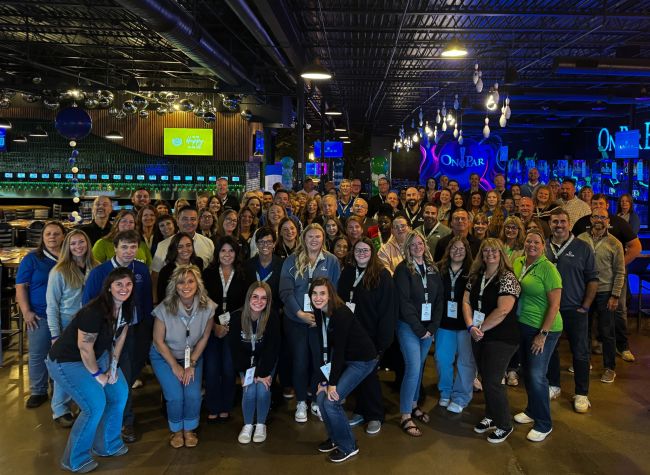 Over one hundred Peoples Bank associates pose for a photo during the Fall 2026 President's Club employee recognition event.